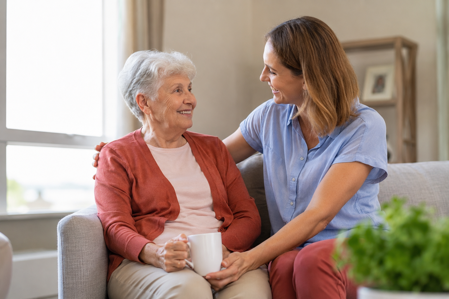 Caregiver providing compassionate in-home support to an older adult, promoting aging well at home and independent living