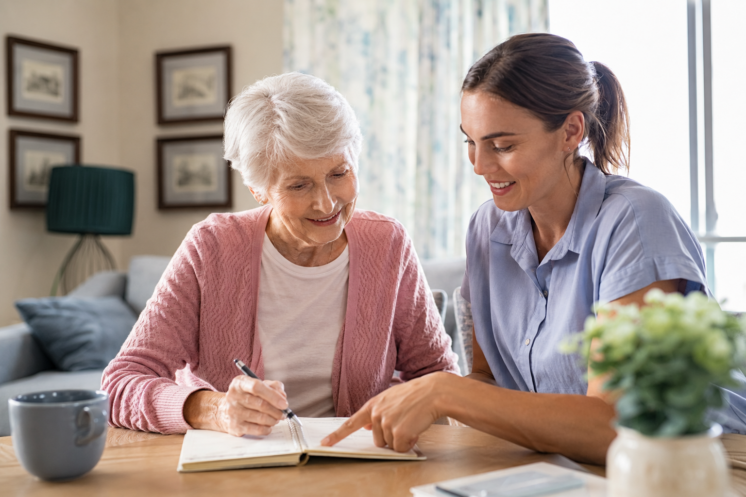 Senior care planning with an older woman and caregiver reviewing her care routine at home