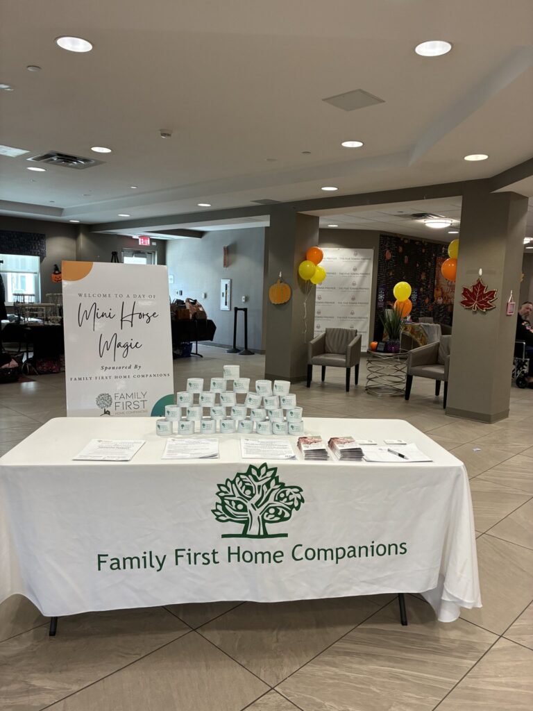 Family First Home Companions information table at Mini Horse Day at The Five Towns Premier